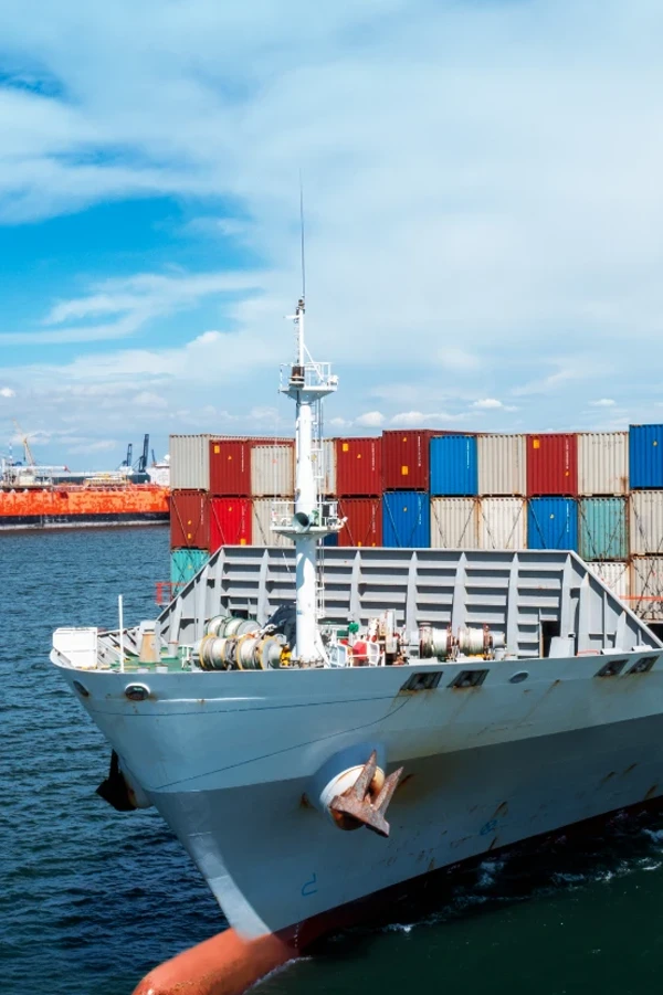 aerial side view cargo ship carrying container running export goods from cargo yard port other ocean concept freight shipping ship vertical